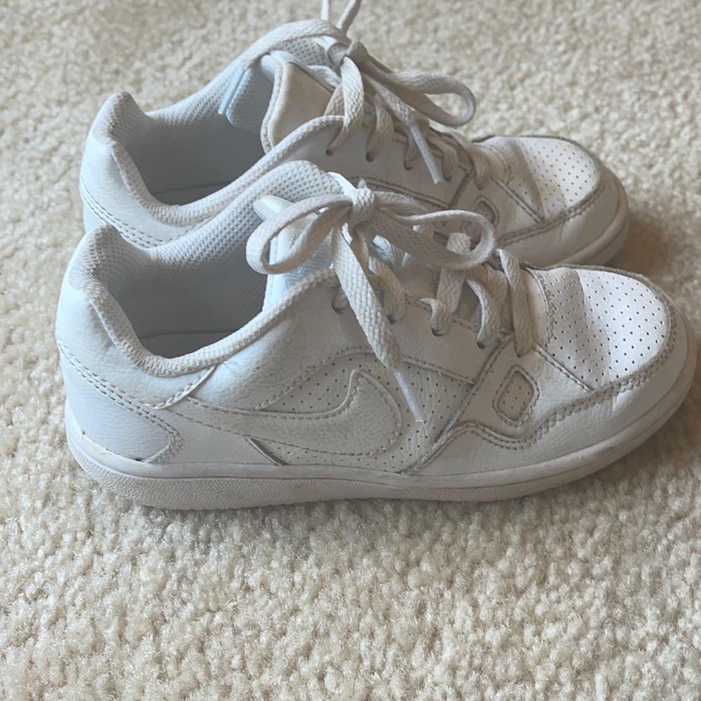 All white Nike little boys sneakers